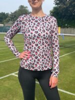 Female tennis player wearing a Pokita base layer, style grey & coral leopard